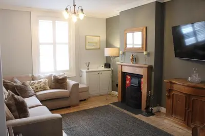 a living room with a couch and a fireplace at Charming 4-Bed in Llangollen in Llangollen