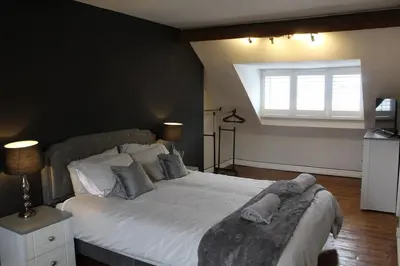 a bedroom with a large white bed with a window at Charming 4-Bed in Llangollen in Llangollen