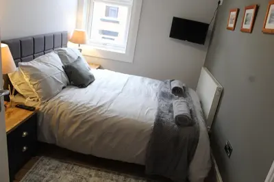 a bedroom with a bed and a window at Charming 4-Bed in Llangollen in Llangollen