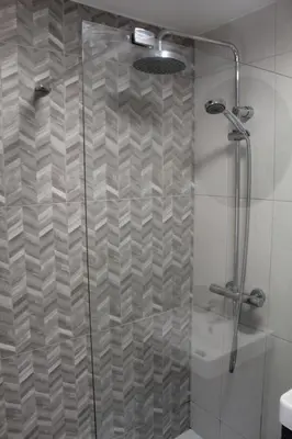 a shower with a glass door in a bathroom at Charming 4-Bed in Llangollen in Llangollen