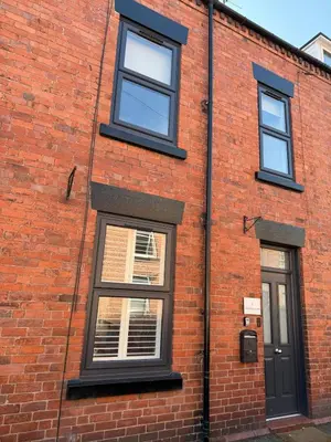 a brick building with three windows and a door at Charming 4-Bed in Llangollen in Llangollen