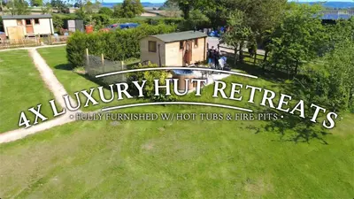 a sign that reads ay luxury huts retreat in a park at Hot Tub Luxury Glamping - Private Stargazing Patio in Yarpole