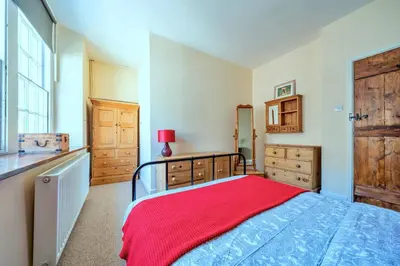 a bedroom with a bed with a red blanket at Finest Retreats - Yr Daflod in Brecon