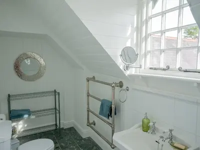 a bathroom with a sink and a toilet and a window at Coach House in Llanwrtyd Wells