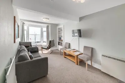 a living room with a couch and a table at Aberdyfi Sea View Apartment in Aberdyfi