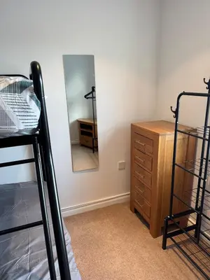 a bedroom with a bed and a dresser and a mirror at Modern, sleeps 6, rural market town, Llani in Llanidloes
