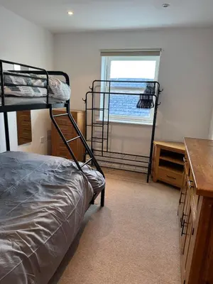 a bedroom with two bunk beds and a window at Modern, sleeps 6, rural market town, Llani in Llanidloes