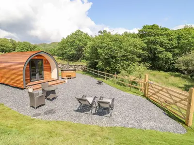 a gazebo with a picnic table and chairs in a yard at Eirlys in Dolgellau