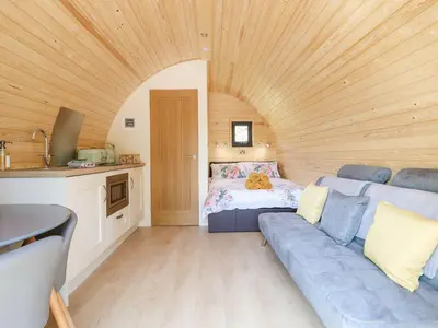 a living room with a couch and a bed at Eirlys in Dolgellau