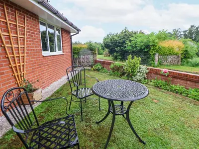 a table and chairs in the yard of a house at 2 Mountain View in Wrexham