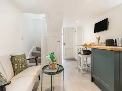 a living room with a couch and a table at The Little House - Uk49129 in Stapleton
