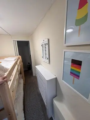 a room with two bunk beds and a painting on the wall at The Cottage on the Rock in Barmouth