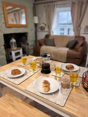 a table with plates of food on top of it at The Cottage on the Rock in Barmouth