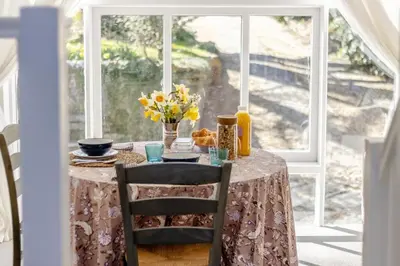a table with a table cloth and flowers on a window at 1 Bed in Culmington oc-t31830 in Culmington