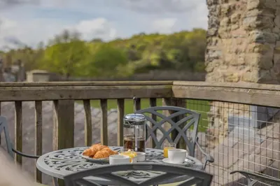 a table with a plate of food on a balcony at 2 Bed in Ludlow oc-c31883 in Ludlow