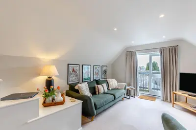 a living room with a green couch and a television at 2 Bed in Ludlow oc-c31883 in Ludlow
