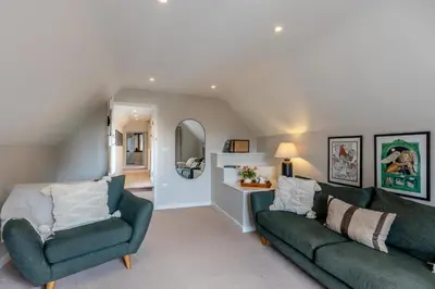 a living room with two green couches and a mirror at 2 Bed in Ludlow oc-c31883 in Ludlow