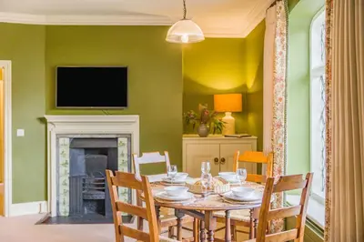a dining room with a table with chairs and a fireplace at 2 Bed in Ludlow oc-s31884 in Ludlow