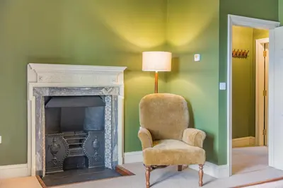 a living room with a chair and a fireplace at 2 Bed in Ludlow oc-s31884 in Ludlow