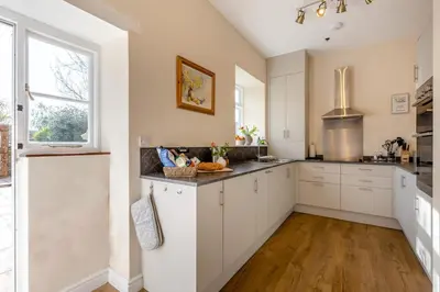 a large kitchen with white cabinets and a window at 2 Bed in Ludlow oc-d31885 in Ludlow