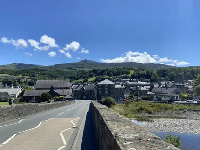 a bridge over a road with a town in the background at 3 Bed in Dolgellau oc-h31822 in Dolgellau