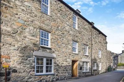 an old stone building with white windows and a door at 3 Bed in Dolgellau oc-h31822 in Dolgellau
