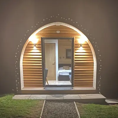a room with an arched window with a bedroom at Mynd View Pods Cedar in Craven Arms
