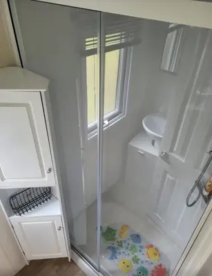 a glass shower in a bathroom with a sink at River View Modern 3 Bedroom Pet Friendly in Clarach Bay in Aberystwyth
