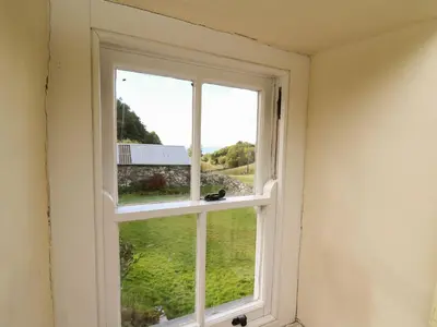 a window in a room with a view of a yard at Tyn Y Graig in Arthog