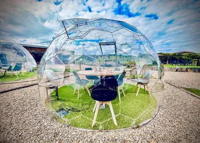 a glass dome with a table and chairs in it at Meadow Springs Country & Leisure Park in Caersws