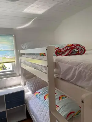 a bedroom with two bunk beds and a window at Awel Mor Beautiful Pet Friendly Chalet in Clarach Bay in Aberystwyth