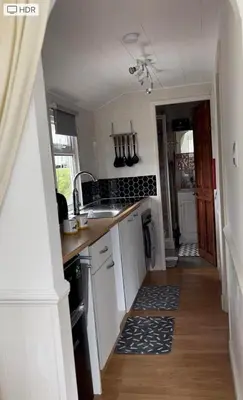 a kitchen with a sink and a counter top at Awel Mor Beautiful Pet Friendly Chalet in Clarach Bay in Aberystwyth
