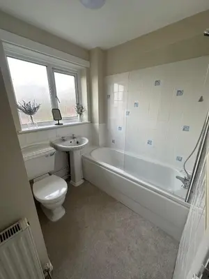 a bathroom with a toilet and a tub and a sink at Hucklemarsh House in Ludlow