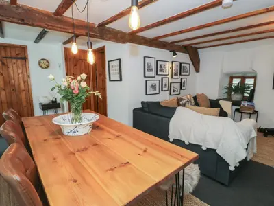 a living room with a wooden table and a couch at Penygrisiau in Barmouth