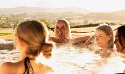 a group of women in the water in a tub at Oolert Treehouse in Hundred House