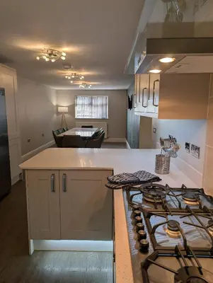 a kitchen with a stove and a counter top at Bwthyn Y Mor in Llanddwywe