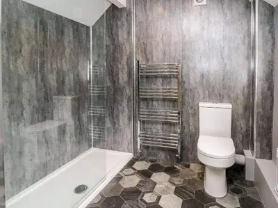 a bathroom with a toilet and a shower and a tub at Beautiful cottage with log burner in Dolgellau