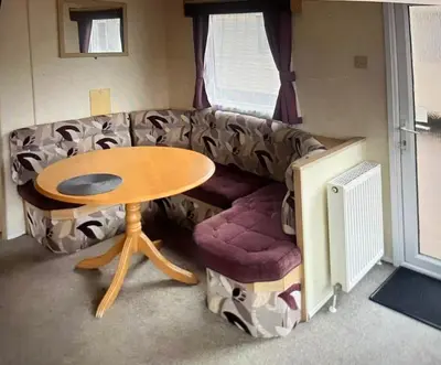 a living room with a couch and a table at Sylvan Near Hay on Wye in Rhos-gôch