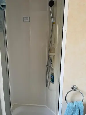 a shower stall in a bathroom with a blue towel at Sylvan Near Hay on Wye in Rhos-gôch