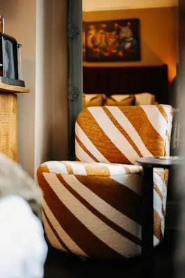 a striped blanket on a bed in a room at Unique Shrewsbury Rooms in Shrewsbury