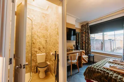 a hotel room with a shower and a bedroom at Unique Shrewsbury Rooms in Shrewsbury