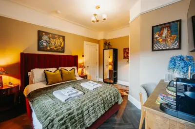 a bedroom with a bed with two towels on it at Unique Shrewsbury Rooms in Shrewsbury