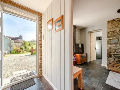 a room with a large window and a stone wall at West Llwyn - Uk41757 in Rhyd Owen