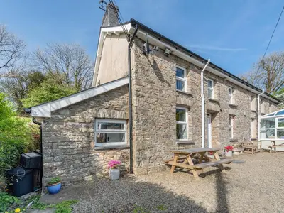a stone building with a picnic table in front of it at West Llwyn - Uk41757 in Rhyd Owen