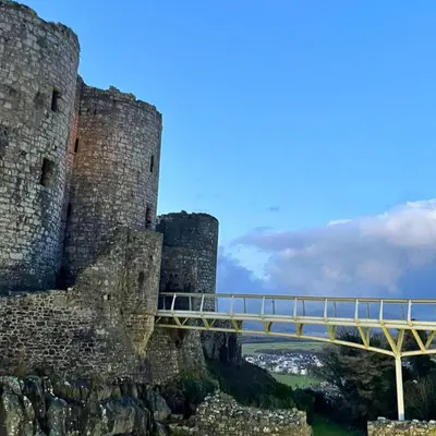 a bridge over a castle with a blue sky at Gwyneska in Llanaber