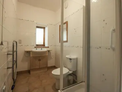 a bathroom with a toilet and a sink at Cae'n Y Coed Barn in Talsarnau