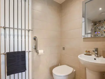a bathroom with a toilet and a sink at The Vinery - Uk49583 in Shrewsbury