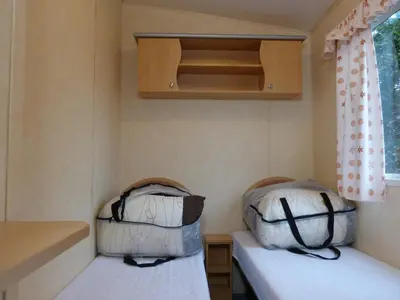 two beds in a small room in a trailer at Northfield Holiday Park in Borth