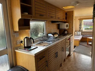 a kitchen with a sink and a counter top at Northfield Holiday Park in Borth