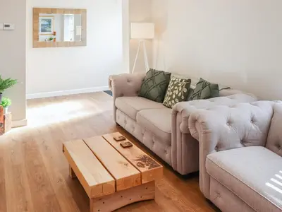 a living room with a couch and a coffee table at Cae Cwta in Llanddwywe